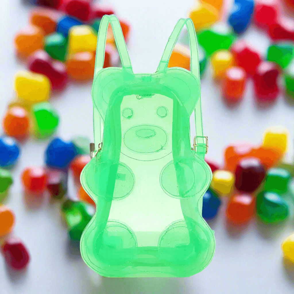 Vibrant green gummy bear 🐻 transparent backpack with glitter ✨ adjustable straps in colorful background of gummy candies 🍬